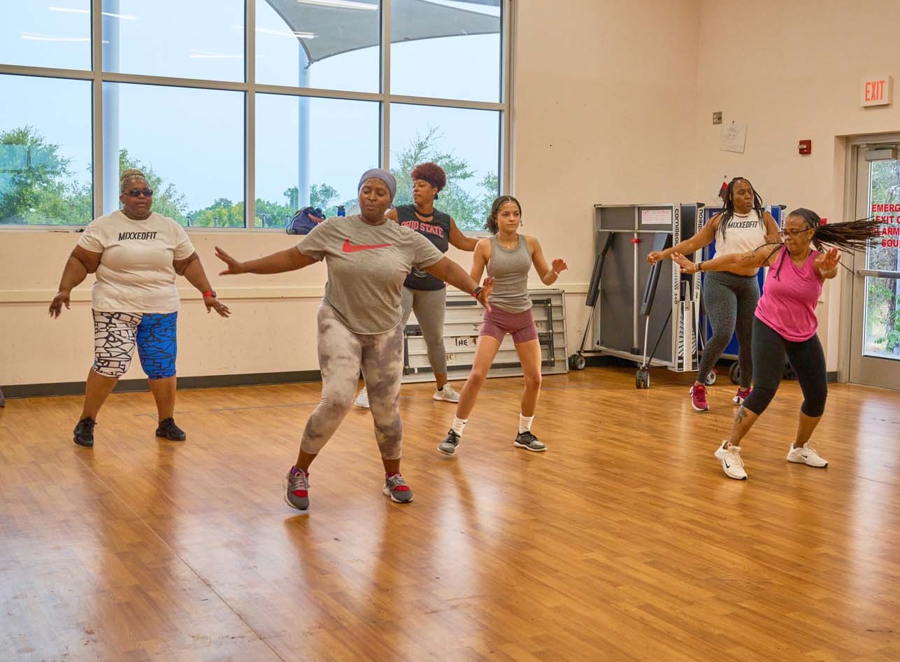 A group of women participating in a Stronger Texas MixxedFit class